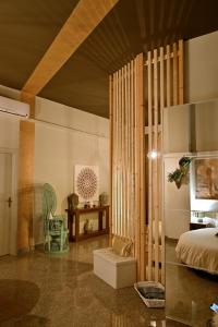 a bedroom with a bed and a table and a chair at Cerchio di Luce in Locorotondo