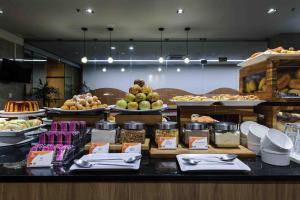 a buffet line with different types of food on display at Vitoria Praia Hotel in Vitória