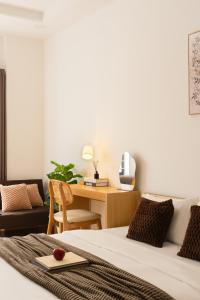 a bedroom with a bed and a desk with a desk at The Hammond Saigon in Ho Chi Minh City +235 photos