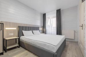 a bedroom with a large bed and a window at Milli&Jon SPA in Bukovel
