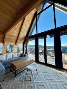 a living room with a couch and a table at Vikendica Nomadova Koliba in Tvrdimići +17 photos
