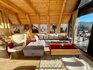a living room with a couch and a table at Vikendica Nomadova Koliba in Tvrdimići