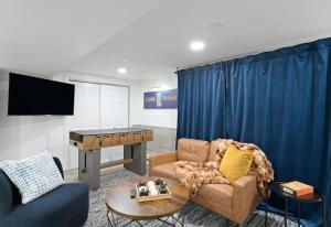 a living room with a ping pong table at The Harper Loft near Manhattan with NYC skyline view in Hoboken