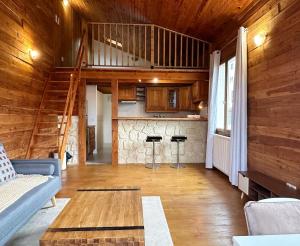 een woonkamer met een bank en een tafel bij Duplex Chalet style private yard 150m to RER in Bagneux