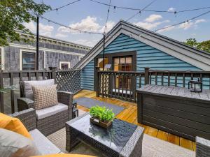 a blue house with a patio with a table at The Harvard Loft with Game Room and Free Parking Near Harvard Square in Cambridge