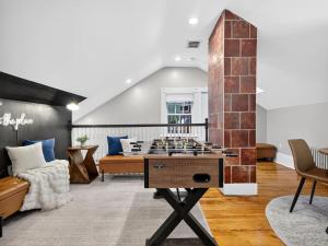 a living room with a chess game on a table at The Harvard Loft with Game Room and Free Parking Near Harvard Square in Cambridge