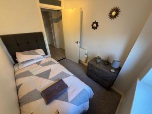 a bedroom with a bed and a mirror on the wall at Canal Side Retreat in Maldon