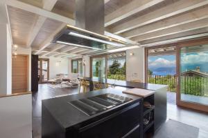 a kitchen with a black counter top and some windows at Ca Bosca - Fine Living in Torri del Benaco