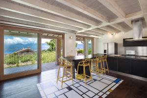 a kitchen with a table and chairs and a balcony at Ca Bosca - Fine Living in Torri del Benaco