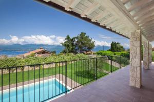 a swimming pool on a balcony with a view of the ocean at Ca Bosca - Fine Living in Torri del Benaco