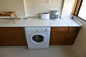 a washing machine in a small kitchen with a counter at Apartment with 2 bedrooms in Infantado in Loures in Loures