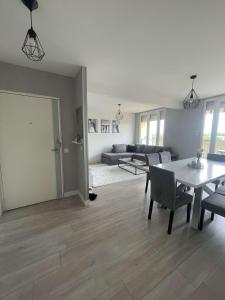 a living room with a table and a couch at Chambre meublé Lormont in Lormont