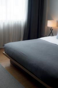 Postel nebo postele na pokoji v ubytování Quies Hotel