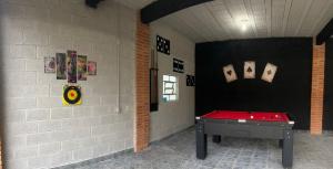 a room with a ping pong table in it at Chácara Ana Clara in Cotia