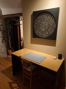 a wooden desk with a laptop on top of it at La Petite Longère in Talcy