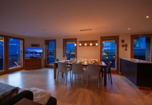 a kitchen and dining room with a table and chairs at Chalet Waldschluecht in Wengen