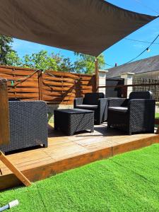 een groep stoelen op een houten terras bij La Petite Longère in Talcy