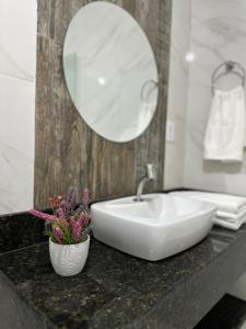a bathroom with a white sink and a mirror at Casa do Sertão in Piranhas +37 photos