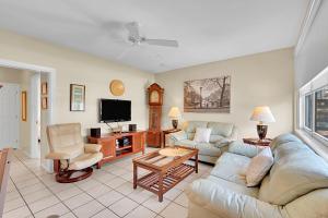 a living room with a couch and a tv at Holiday Isle Yacht Club in Fort Lauderdale