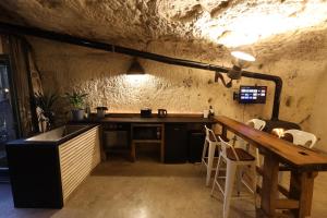 a kitchen with a counter and a table in a cave at Le Cavernacle in Montrichard