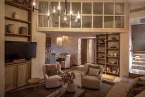 a living room with a couch and a dining room at Forest Within - Wellness Villa in Archanes in Káto Arkhánai