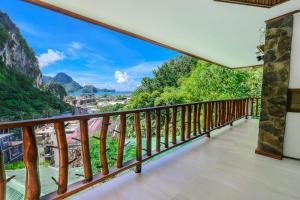 a balcony with a view of the mountains at El Nido Viewdeck Cottages in El Nido