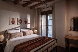 a bedroom with a large bed and a window at Forest Within - Wellness Villa in Archanes in Káto Arkhánai +35 photos