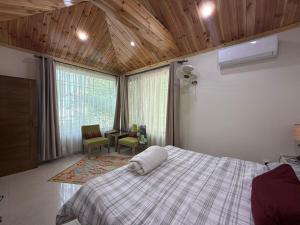 Giường trong phòng chung tại Haven Lodge Bhurban, Cheerful 3BR Cottage