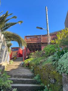 a stairway leading up to a house with a balcony at Casa Mirador Pichilemu in Pichilemu