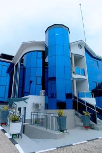 a blue building with benches in front of it at Dorlan Hotel in Kigali