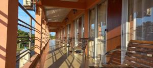 a balcony with chairs and tables on a building at Aparthotel Agave in Termas del Daymán