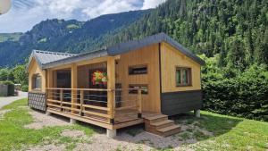 a tiny house sitting on top of a field at Camping L'Oustalet in Châtel