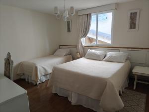 En eller flere senge i et værelse på Pousada Serrano Village - 2km do Capivari