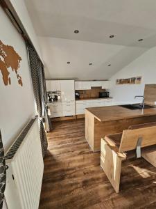 a large kitchen with a table and a counter at Central Apartment in Radstadt