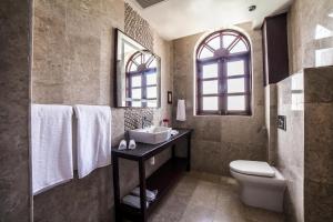 a bathroom with a sink and a toilet at BW Plus Zanzibar in Zanzibar City