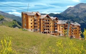 a large building on the side of a hill at Résidence Odalys Rochebrune in Orcières