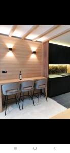 a dining room with a table and two chairs at WOODSIDE SPA AND PARKING 323 Kopaonik011 in Kopaonik