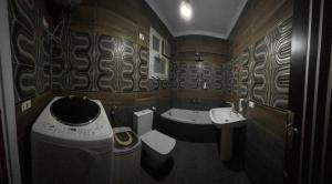 a small bathroom with a toilet and a sink at Egypt Love in Al Badrashayn