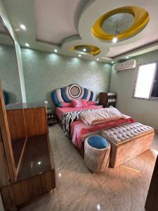 a bedroom with a large bed and a mirror at Egypt Love in Al Badrashayn