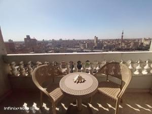a table and chairs on a balcony with a view at Egypt Love in Al Badrashayn