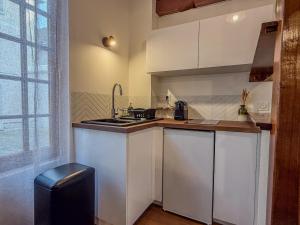 eine kleine Küche mit Spüle und Herd in der Unterkunft Studio cœur de Chartres, à côté de la cathédrale in Chartres + 3 Fotos