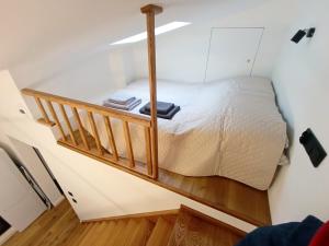 a small bedroom with a bed in a room at Apartament Chyża , jacuzzi , taras , parking in Zamość
