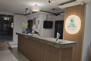 a bar in a restaurant with a sign that reads oasis dial nap hotel at Olas del Mar Hotel by GHO Hoteles in Santa Marta
