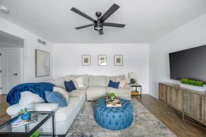 a living room with a couch and a ceiling fan at Private Pool Haven Backyard & Putting Green in Phoenix