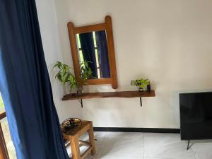 a living room with a mirror and a tv at Lio Villa in Habaraduwa Central