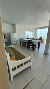 a living room with a table and a dining room at Residencial Da Cal in Torres