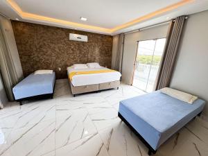 En eller flere senge i et værelse på Eficiência - Casa Recanto dos Ventos