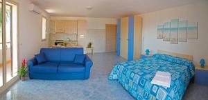 a bedroom with a blue bed and a blue chair at Le Ville della Contea -Vacation rentals in Mascali