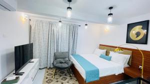 En eller flere senge i et værelse på JANO HOUSE AppartHôtel