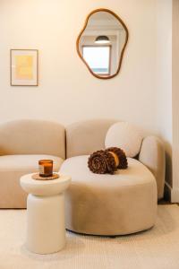 a living room with a chair and a mirror at Le Chéron - Confort, Wi-Fi & commerces à deux pas in Caen